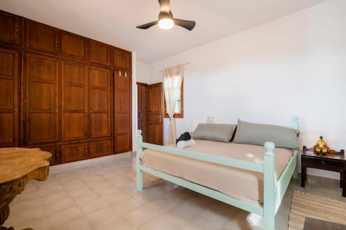 a bedroom with a bed and a ceiling fan at Villa Panagiota, Pefkos in Pefki Rhodes