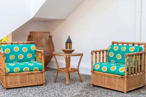 three chairs and a table in a room at Villa Panagiota, Pefkos in Pefki Rhodes