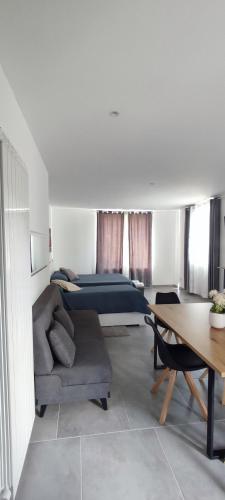 a bedroom with a bed and a couch and a table at Nautica Tarello - Casa Ena BeB in Viverone
