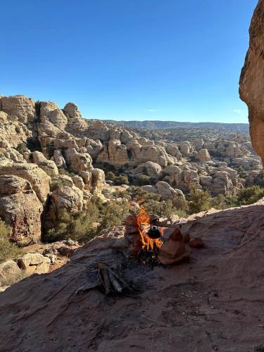 a camp fire on the side of a rocky mountain at Dana Mount View the highest hotel in Jordan in Dana