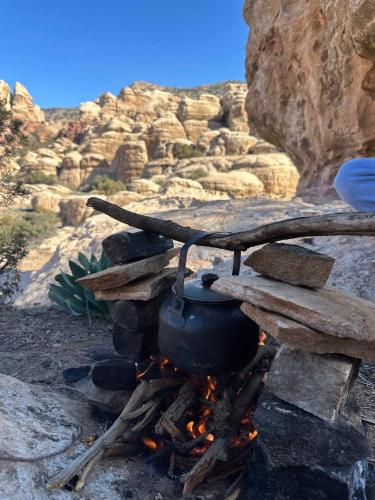 a pot sitting on top of a camp fire at Dana Mount View the highest hotel in Jordan in Dana