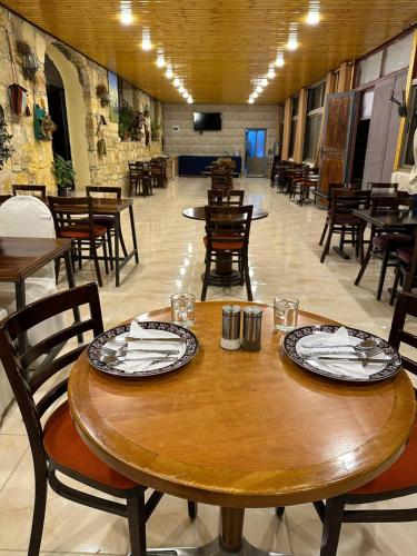 a dining room with wooden tables and chairs and tables sidx sidx sidx at Dana Mount View the highest hotel in Jordan in Dana