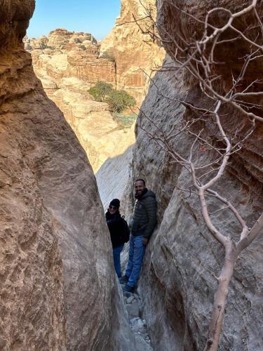 two men are standing in a slot canyon at Dana Mount View the highest hotel in Jordan in Dana