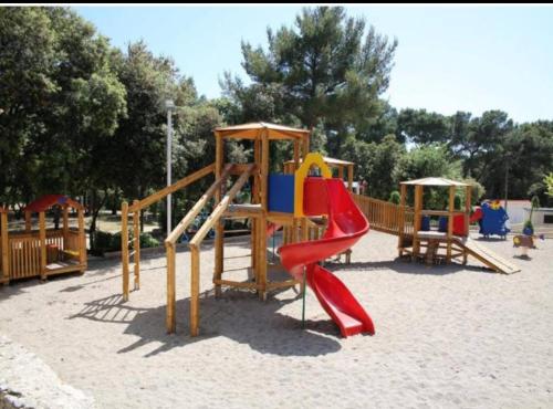 a playground with a slide and a slideintend at Mobile home Lea, kamp Soline in Biograd na Moru