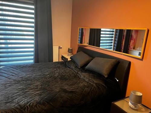 a bedroom with a bed and a mirror at Residentie Pelikaan - nice view on the Leie in Deinze