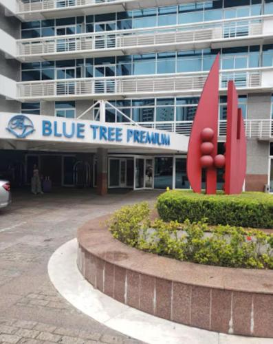 a blue tree programme sign in front of a building at Flat Blue Tree Premium Verbo Divino in Sao Paulo