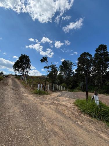 a dirt road with a fence on the side at The house in the mountains in Tinjacá