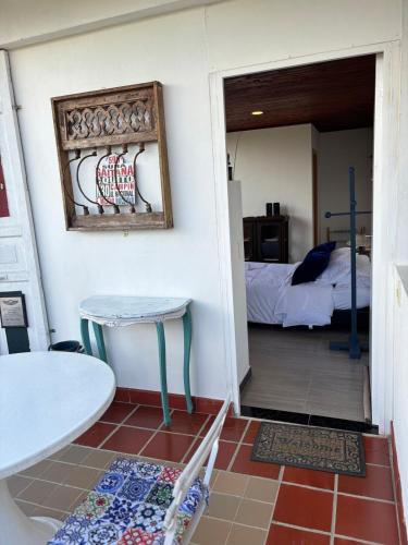 a room with a table and a room with a bed at The house in the mountains in Tinjacá