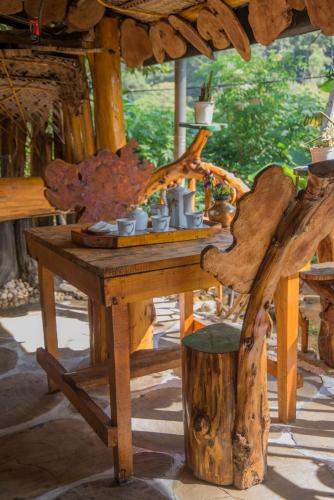 a wooden table with cups on top of it at Blooming Rose Homestay in Ohiya