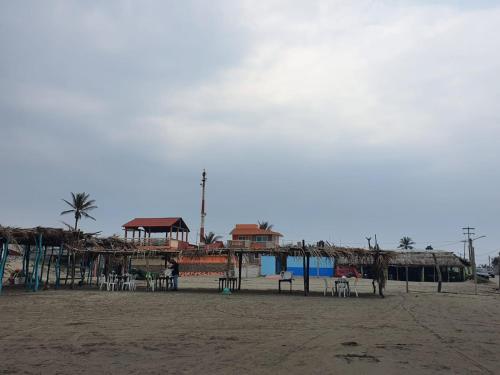 a building on the beach with tables and chairs at Casa Vargas Veracruz in Antón Lizardo