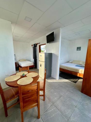 a room with a table and chairs and a bed at Family-friendly with balcony and terrace in Puerto Ayora