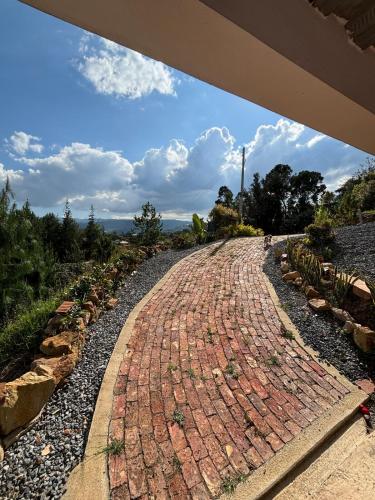 a cobblestone road in a garden at The house in the mountains in Tinjacá