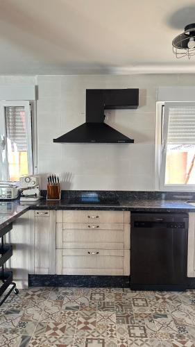 a kitchen with a counter top and a stove top oven at El piso del pueblo in Mansilla de las Mulas