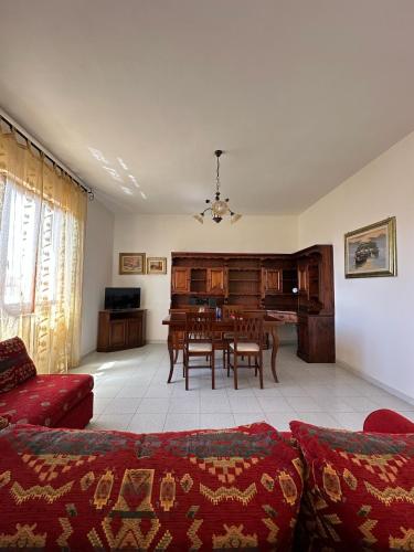 a living room with a couch and a dining room at Sa Domu di Beppe e Nora in San Giovanni Suèrgiu