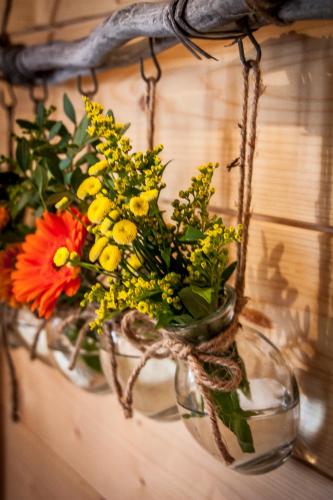 a glass vase filled with flowers on a wall at Almhütte Falkert in Patergassen
