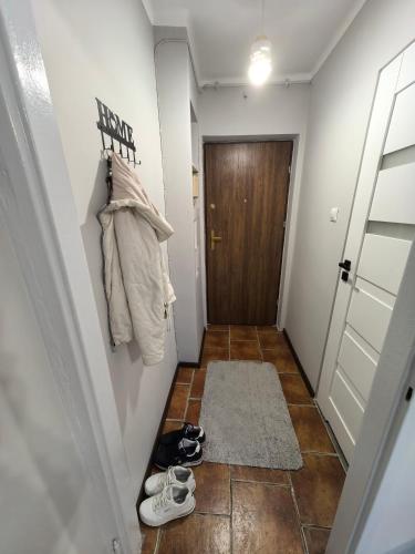 a hallway with shoes on the floor next to a door at Mieszkanie w centrum blisko dworca in Ełk
