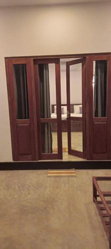 a pair of sliding glass doors in a room at The Nest in Weligama