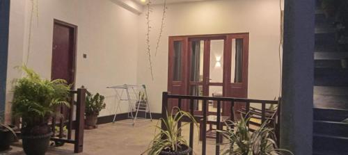a room with plants and a door and a tripod at The Nest in Weligama