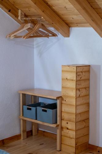 a wooden shelf with two boxes next to a wooden cabinet at Adega dos Avós - Casa completa in Alcobaça