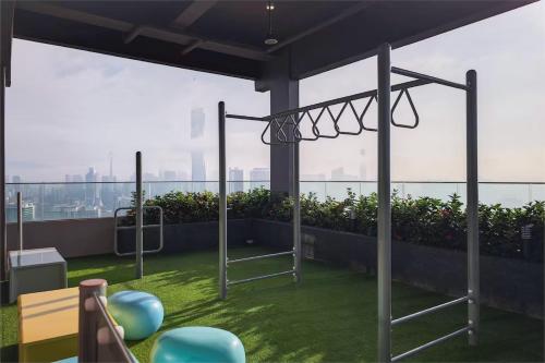 a gym on the roof of a building at Riveria City KL Sentral by Nest Suite in Kuala Lumpur