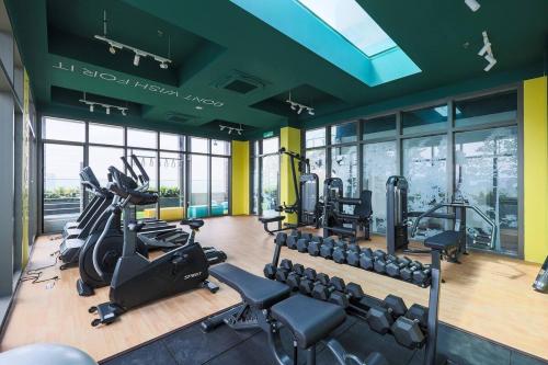 a gym with treadmills and ellipticals in a building at Riveria City KL Sentral by Nest Suite in Kuala Lumpur