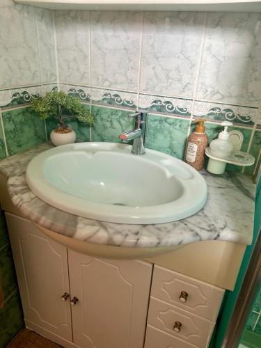 a bathroom sink with a white counter top at MagicLoc in Esbly