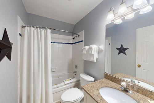 a bathroom with a sink and a toilet and a tub at Condo 310 at North Creek Resort in Blue Mountains