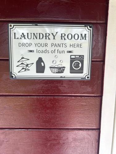 a sign on a door that says laundry room drop your pants here loads of fun at MagicLoc in Esbly