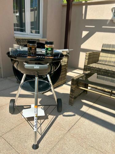 a barbecue grill sitting on top of a patio at MagicLoc in Esbly