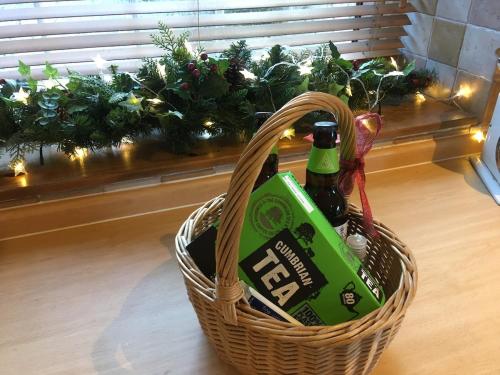 a basket with a bottle of beer in it at High House Cottage - A traditional home from home in St Bees