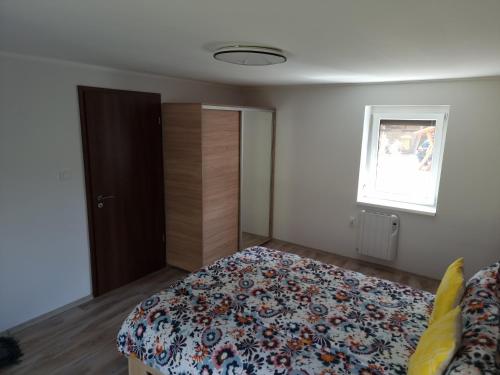 a bedroom with a bed and a window at Habitat of Dreams in Makó
