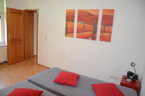 een slaapkamer met een bed met rode kussens erop bij Wölfele Apartment in Quedlinburg