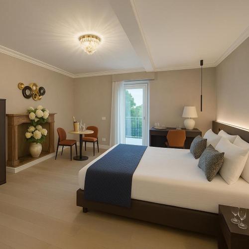 a bedroom with a large bed and a table and chairs at Villa Valesca in Stresa