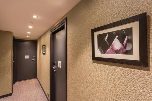 a hallway of a hotel room with a picture on the wall at Hotel Yllen Eiffel in Paris