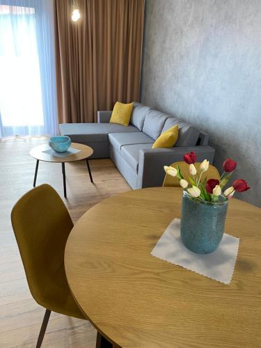a living room with a table and a couch at Diamond Houses in Námestovo