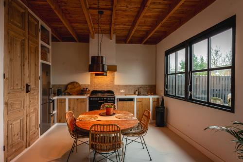a kitchen with a table and chairs in a room at Rustic Lake House in Vinkeveen