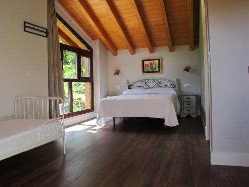 a bedroom with a bed and a large window at Casa Vacacional La Pedrera in Baró