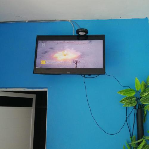 a flat screen tv hanging on a blue wall at Casa Vargas Veracruz in Antón Lizardo