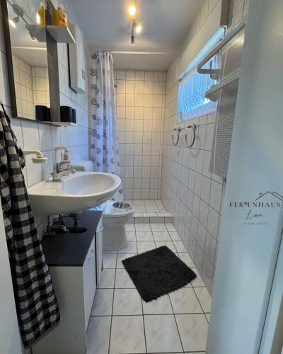 a bathroom with a sink and a toilet at Ferienhaus Lion in Neustadt-Glewe