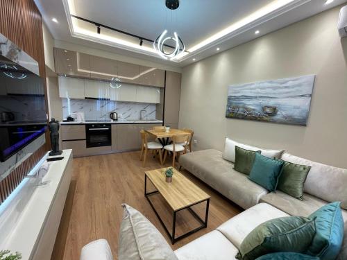 a living room with a couch and a table at City Center Deluxe in Durrës