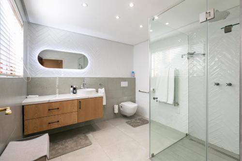 a bathroom with a shower and a sink and a toilet at Forest Town Getaway close to the Parks in Johannesburg