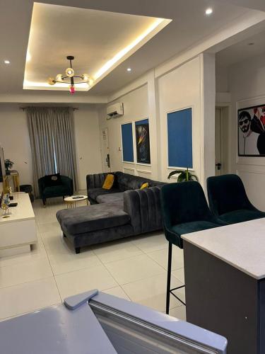 a large living room with a couch and chairs at 2 Bedroom Luxury Apt with Pool & Jacuzzi in Maiyegun