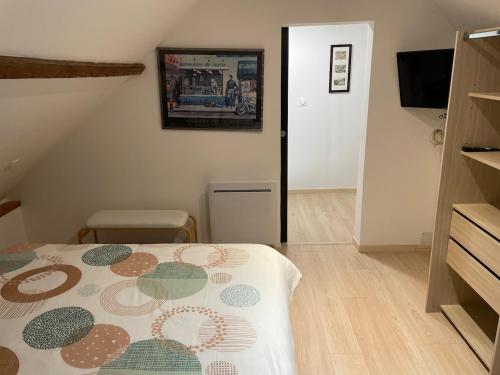 a bedroom with a bed with a flowered comforter on it at Cozy vintage BNB house in Yerville