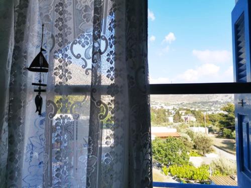 a window with a view of a city at Valentino Apartment Kalymnos in Panormos Kalymnos