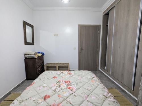 a bedroom with a bed and a dresser at Dar SAÏDA in Marrakech