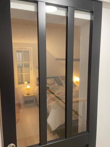 a room with sliding glass doors with a bedroom at Cozy vintage BNB house in Yerville