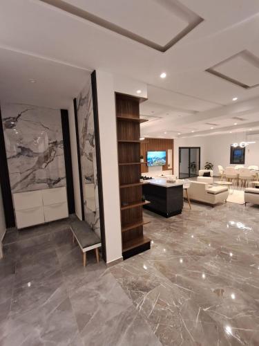 a living room with a couch and a table at Villa Djerba hood in Banī Dinhet