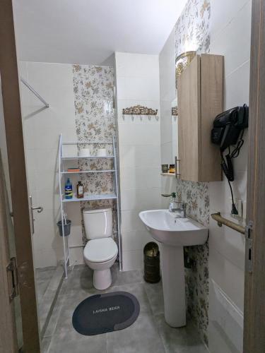 a small bathroom with a toilet and a sink at Dar SAÏDA in Marrakech