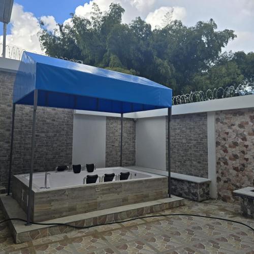 a jacuzzi tub with a blue roof at Hotel Valle del Café - Habitación con Jacuzzi 4 in Sevilla
