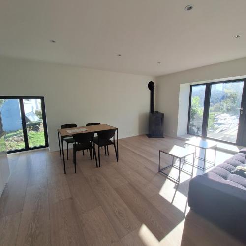 un salon avec une table, des chaises et un canapé dans l'établissement Ma Petite Maison, à Belz